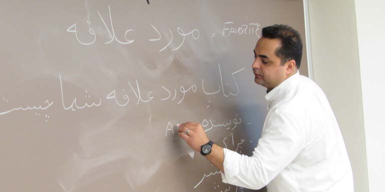 Professor writing on chalkboard